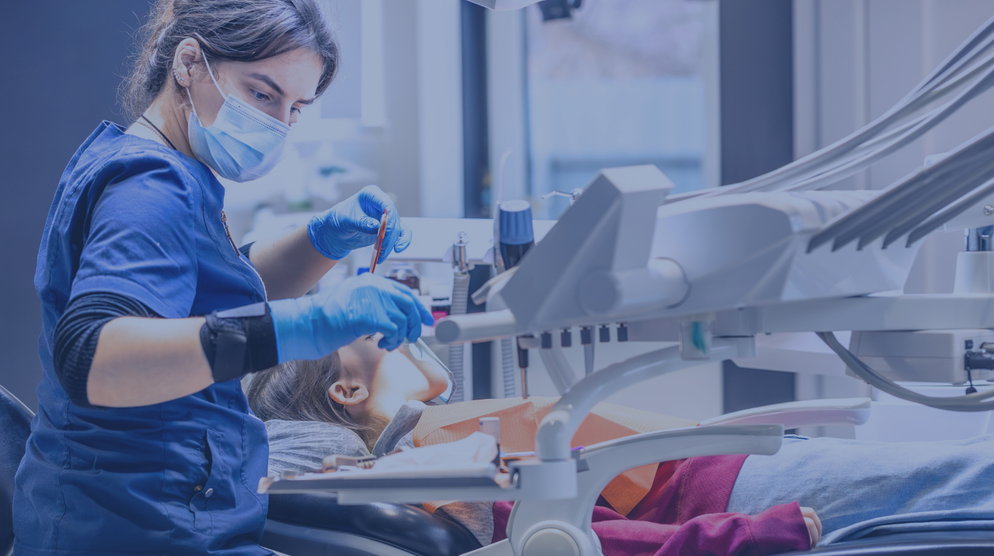 dental hygienist treating a patient