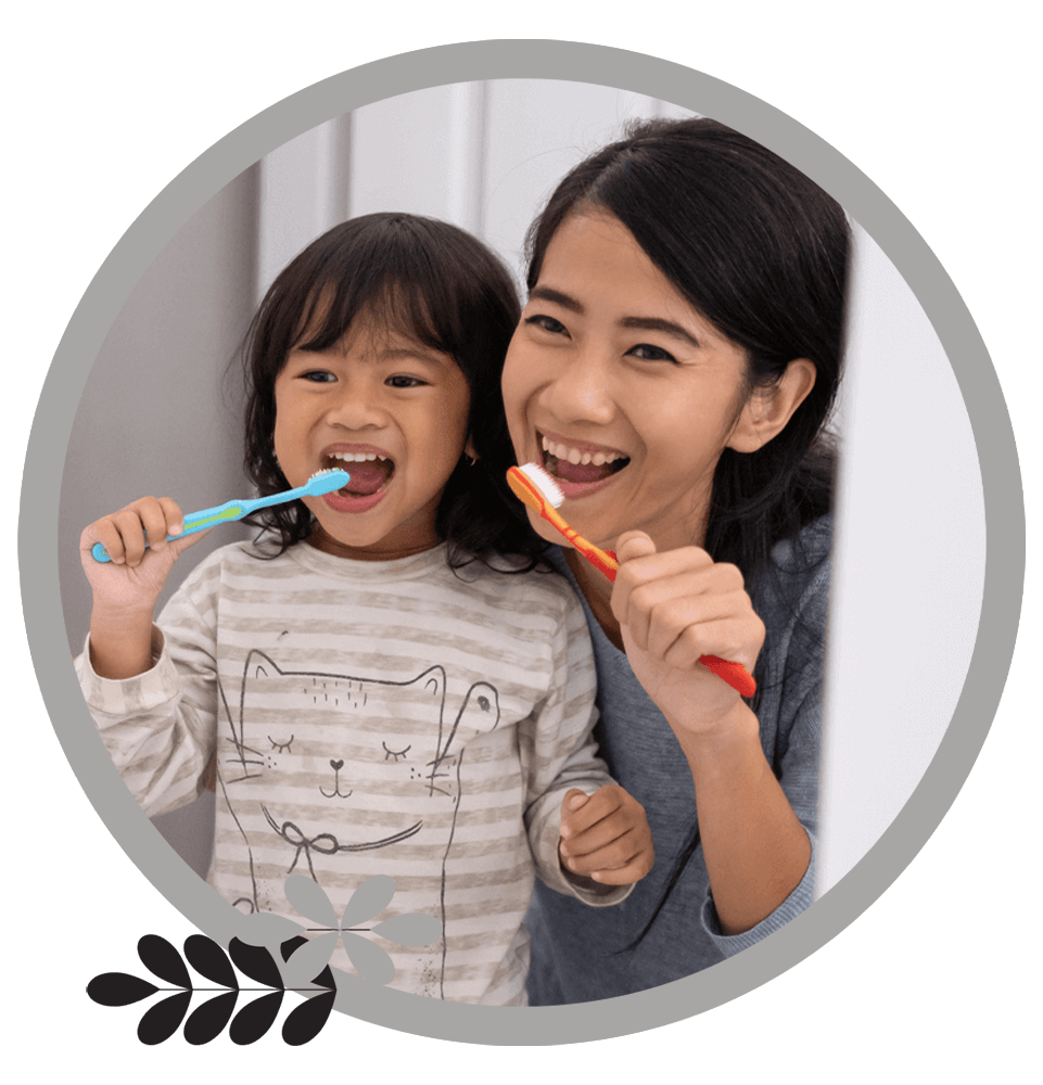 mom and daughter brushing teeth