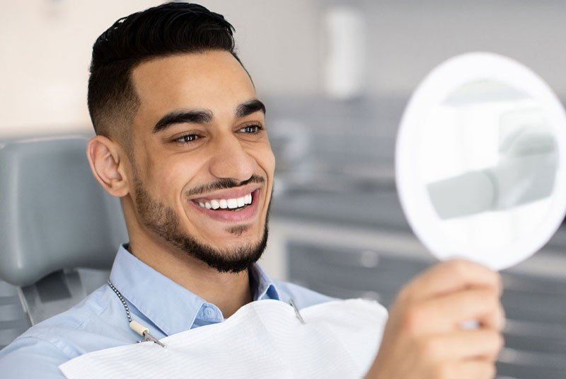 veneer patient looking at new smile